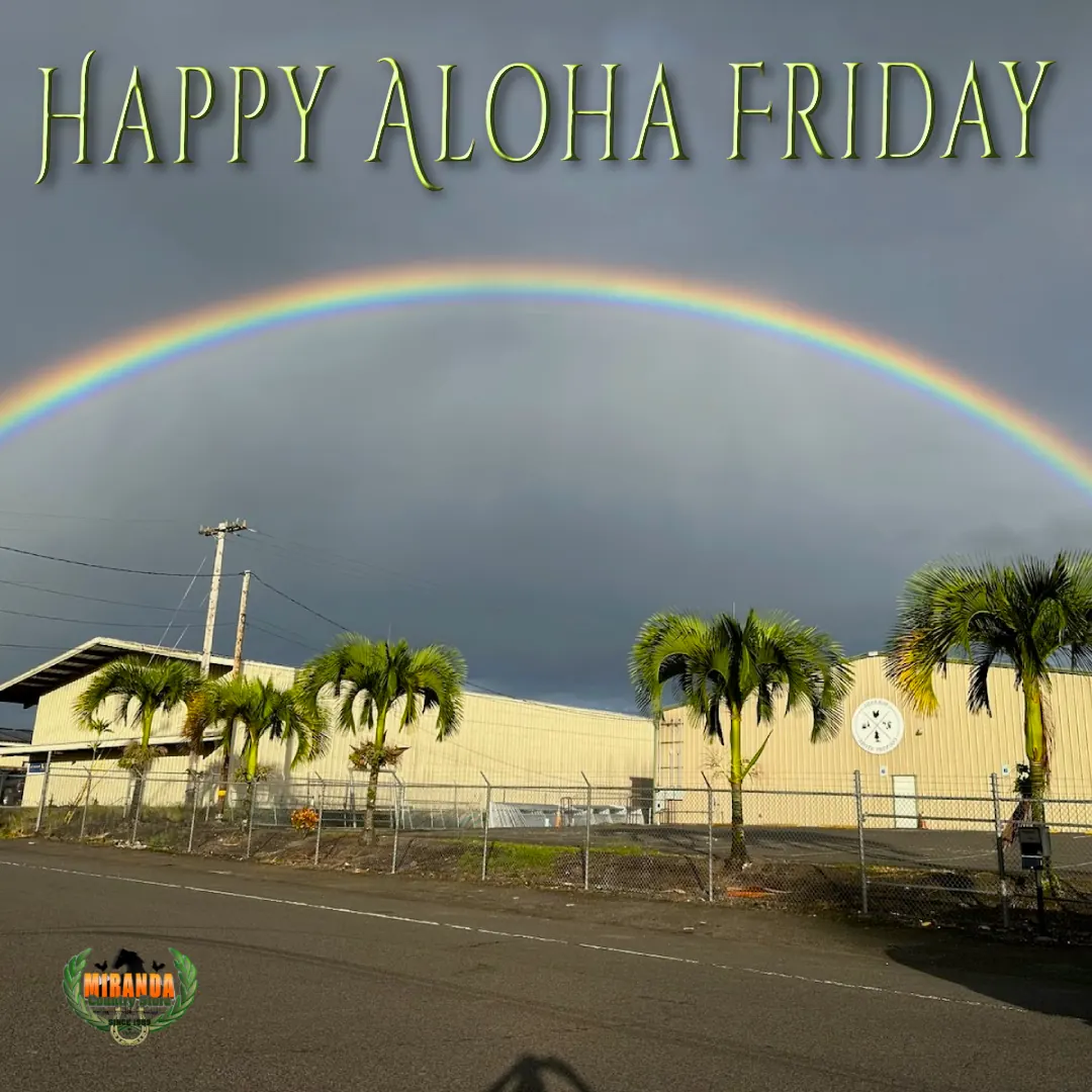 Double rainbow arching over Miranda Country Store warehouse with palm trees and dramatic sky