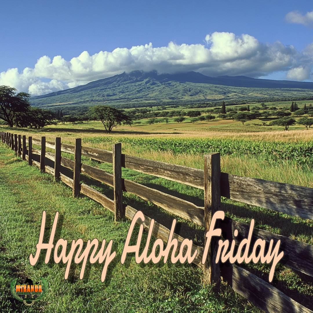 Lush tropical farmland in rural Hawaii with a well-maintained ranch-style wooden fence in the foreground, and Mauna Kea in the background.